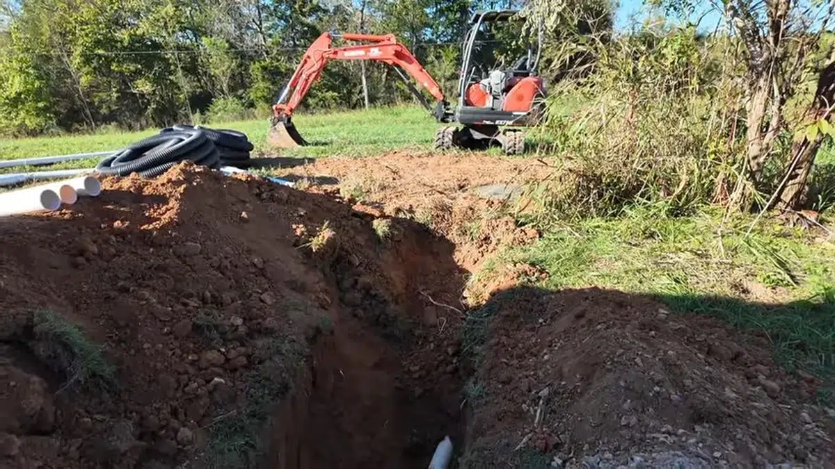 Open trench with sewer or water line replacement pipe exposed for Sewer Line Replacement in Bellflower, CA